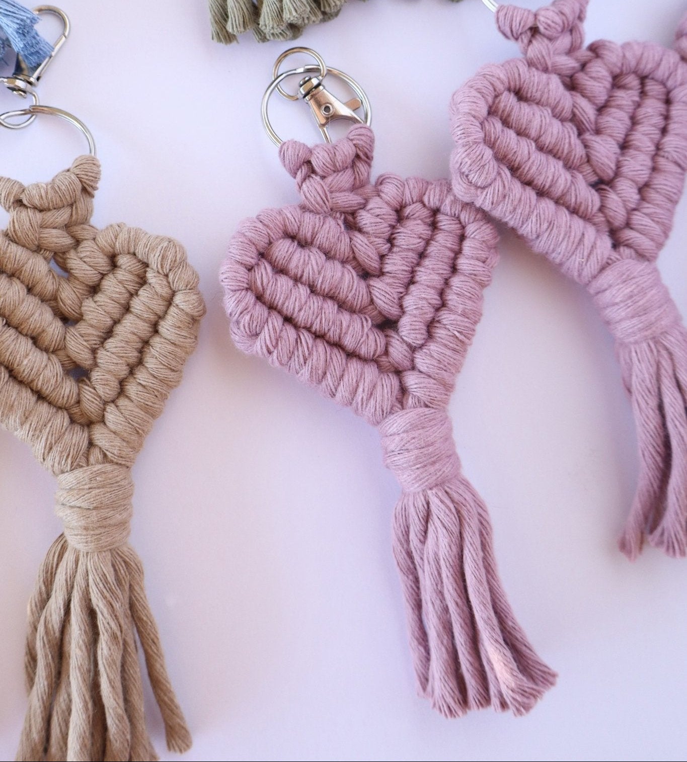 Macrame keychains in various colors on a light background