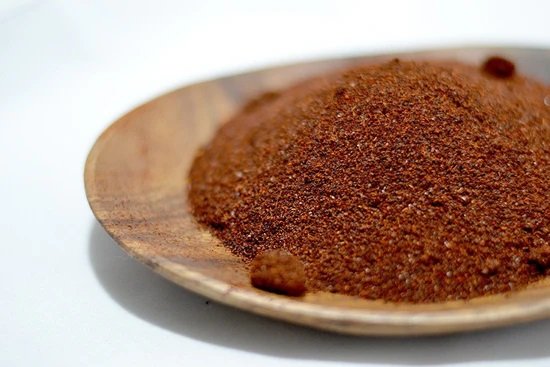 chili powder spice blend on wooden plate